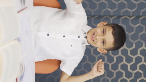Vertical-video-of-Boy-at-home-looking-at-camera-and-rejoicing.